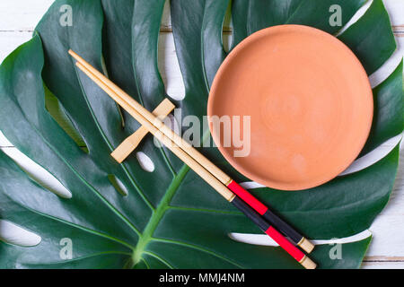 Chopstick and ceramic handmade dish. Asian food concept Stock Photo