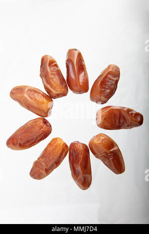 Dry dates isolated on white background. Top view. Flat lay pattern
