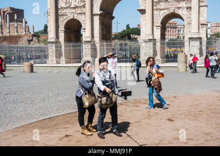 Rome, Italy, 2018 - Tourists next to Colosseum taking selfie Stock Photo