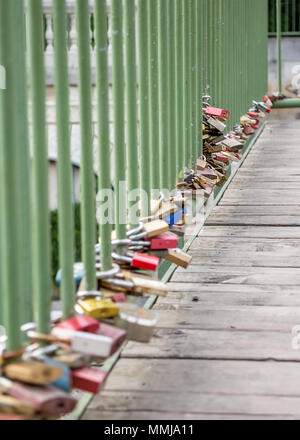 Love padlocks on old pedestrian bridge, low angle view Stock Photo