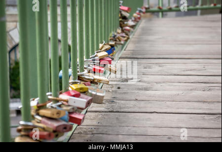 Love padlocks on old pedestrian bridge, low angle view Stock Photo