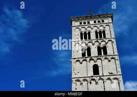 Saint Micheal in Foro Church medieval romanesque bell tower, erected in the 13th century  in the city of Lucca, Tuscany (with blue sky and copy space) Stock Photo