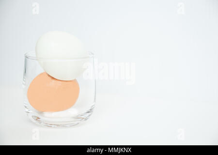 peeled boiled eggs in glass isolated on white background Stock Photo