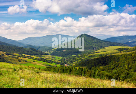 Abranka village in the valley of Carpathian mountains, Ukraine. lovely countryside scenery in early autumn with clouds distant ridge. Stock Photo