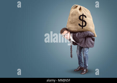 Businessman carrying an oversized moneybag Stock Photo