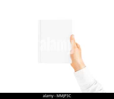 Hand in white shirt sleeve holding closed blank book cover mockup in the hand. Vertical catalogue template mock up hold in arm. Clear surface booklet notebook cover presentation. Textbook catalog. Stock Photo