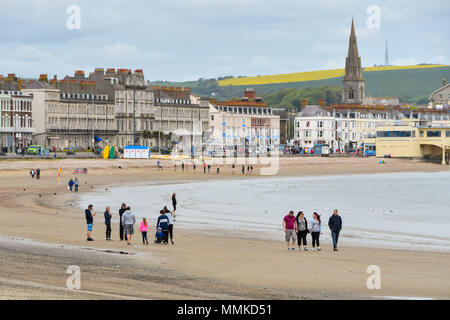 Weymouth, Dorset, UK.  12th April 2018. UK Weather.  Visitors on the beach at the seaside resort of Weymouth in Dorset on an overcast cloudy day.  Picture Credit: Graham Hunt/Alamy Live News Stock Photo