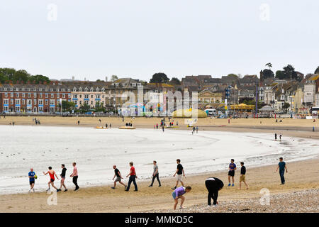 Weymouth, Dorset, UK.  12th April 2018. UK Weather.  Visitors on the beach at the seaside resort of Weymouth in Dorset on an overcast cloudy day.  Picture Credit: Graham Hunt/Alamy Live News Stock Photo