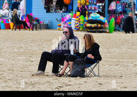 Weymouth, Dorset, UK.  12th April 2018. UK Weather.  Visitors on the beach at the seaside resort of Weymouth in Dorset on an overcast cloudy day.  Picture Credit: Graham Hunt/Alamy Live News Stock Photo