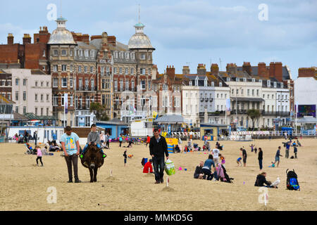 Weymouth, Dorset, UK.  12th April 2018. UK Weather.  Visitors on the beach at the seaside resort of Weymouth in Dorset on an overcast cloudy day.  Picture Credit: Graham Hunt/Alamy Live News Stock Photo