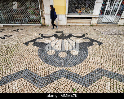27 February 2018: Lisbon, Portugal - Traditional Portuguese Pavement, or calcada portuguese, the tiled pavement found in public areas of Portugal, her Stock Photo