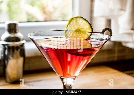 Cosmopolitan Cocktail with shaker on wooden surface. Beverage Concept. Stock Photo