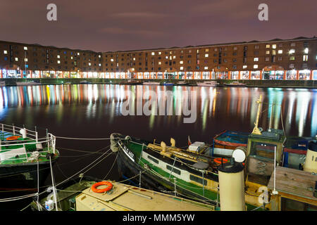 Liverpool, Merseyside, UK - February 19, 2009: Night scene of Albert Docks with reflections across the water on a cloudy winter night Stock Photo