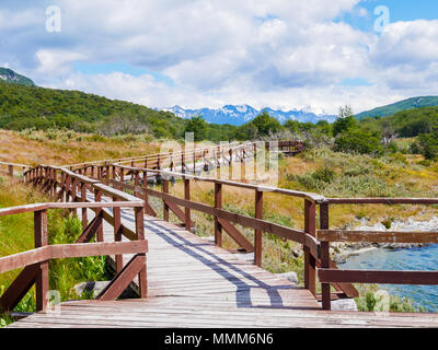 Boardwalk of Puerto Arias in Lapataia Bay with Andes mountains in background, Terra del Fuego National Park near Ushuaia, Patagonia, Argentina Stock Photo