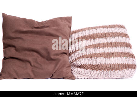 2 brown knitted pillow on a light background Stock Photo