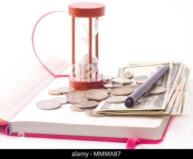 pen and coin on notebook on white background Stock Photo