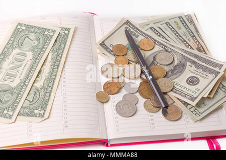 Diary with money and pen isolated on white background Stock Photo