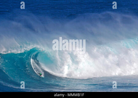 Surfer inside a giant tube in a wave at world-famous Jaws or Peahi surfbreak, Maui, Hawaii, USA Stock Photo