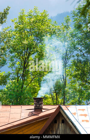 The chimney, from which comes the smoke in the center of the frame Stock Photo