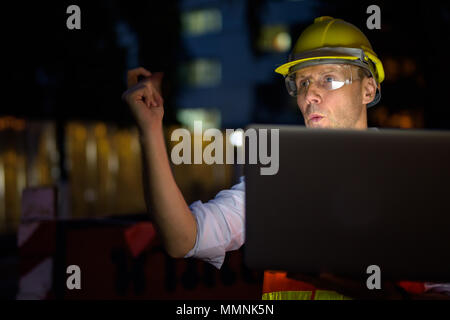 Mature man construction worker at the construction site in the c Stock Photo