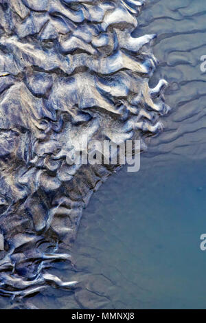 Wave-formed ripples left alongside pools of seawater on the beach of Scarborough’s North Bay. Stock Photo