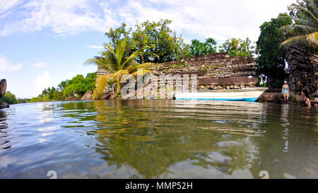 Boat docked in front of an ancient structure at Nan Madol Archeological site, Pohnpei, Federated States of Micronesia Stock Photo