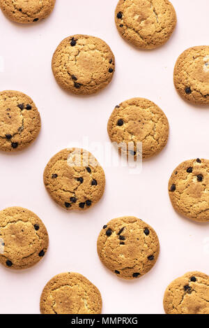 Chocolate chip cookies on pink pastel background, top view. Stock Photo