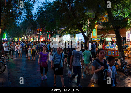 Xian, China - August 5, 2012: People walking in a street of the Muslim Quarter in the city of Xian at night, in China, Asia Stock Photo