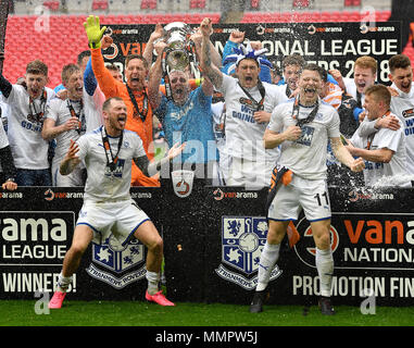 Tranmere Rovers' James Norwood (left), Connor Jennings (right) and team-mates celerabte with the trophy after the game during the Vanrama National League Play-off Final at Wembley Stadium, London. Stock Photo