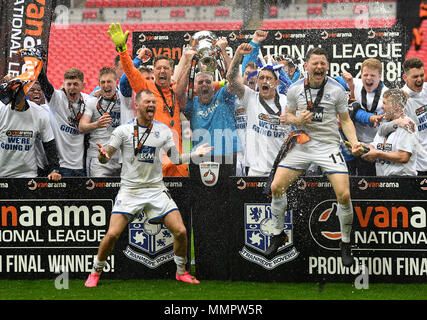 Tranmere Rovers' James Norwood (left), Connor Jennings (right) and team-mates celerabte with the trophy after the game during the Vanrama National League Play-off Final at Wembley Stadium, London. Stock Photo