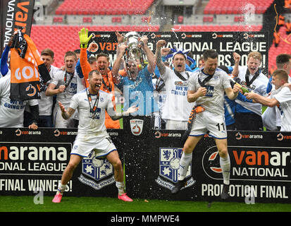 Tranmere Rovers' James Norwood (left), Connor Jennings (right) and team-mates celebrate with the trophy after the game during the Vanrama National League Play-off Final at Wembley Stadium, London. Stock Photo