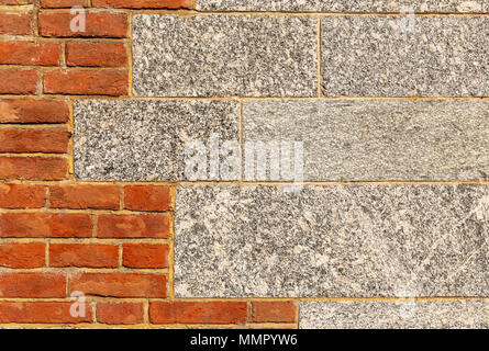 Granite and red brick wall Stock Photo