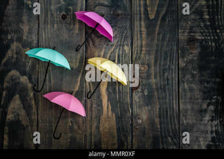 Colorful mini umbrellas on blue wooden background Stock Photo