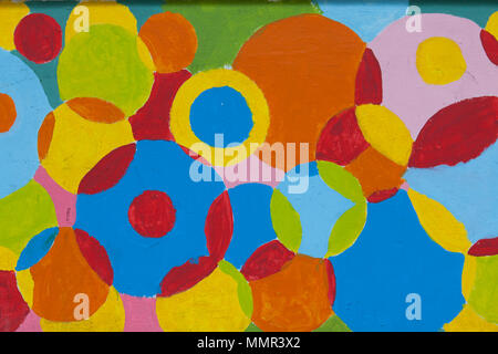 Colourful art painting of circle shape in different colourings on the the wall out in the street, Singapore. Stock Photo