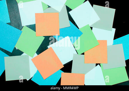 lot of various colored note papers on black background Stock Photo