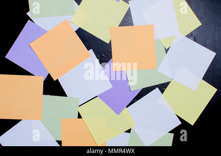 lot of various colored note papers on black background Stock Photo