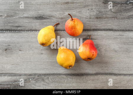 Table top view on four ripe pears on gray wood desk. Stock Photo