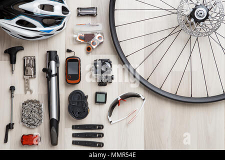 Image of bicycle objects on wooden background. Wheel, helm, seat, helmet, tire. Empty place for inscription Stock Photo