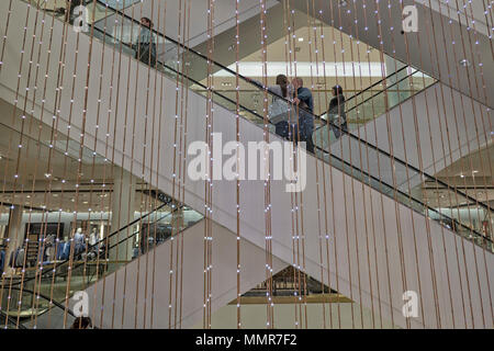 People riding escalator in shopping mall 900 North Michigan Avenue on Magnificent Mile, Chicago, IL, USA Stock Photo