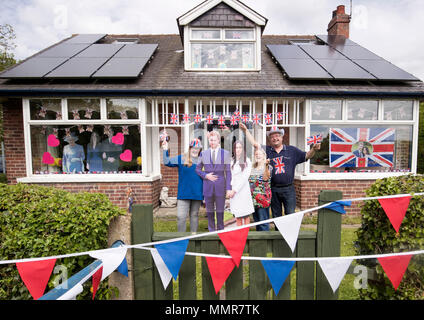 Angela and Richard Rooke and their daughter Jessica with their house near Tadcaster in Yorkshire, that they have decorated ahead of the royal wedding of Prince Harry and Meghan Markle. Stock Photo