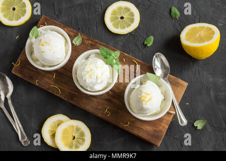 Lemon Ice Cream in bowl. Homemade citrus lemon ice cream (gelato) with mint close up. Stock Photo