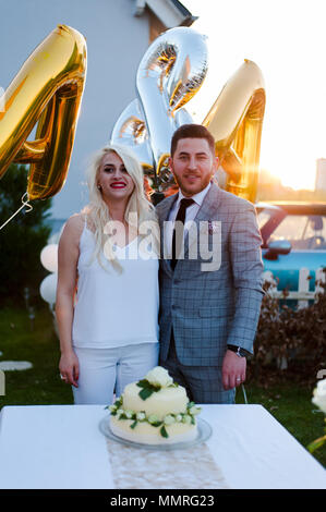 Bride and groom cutting wedding cake Stock Photo