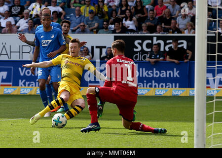 Sinsheim, Germany. 12th May, 2018. Marco Reus (2nd R) of Dortmund shoots as Hoffenheim's goalkeeper Oliver Baumann defends during the Bundesliga match between TSG 1899 Hoffenheim and Borussia Dortmund at Wirsol Rhein-Neckar Arena in Sinsheim, Germany, on May 12, 2018. Hoffenheim won 3-1. Credit: Joachim Bywaletz/Xinhua/Alamy Live News Stock Photo