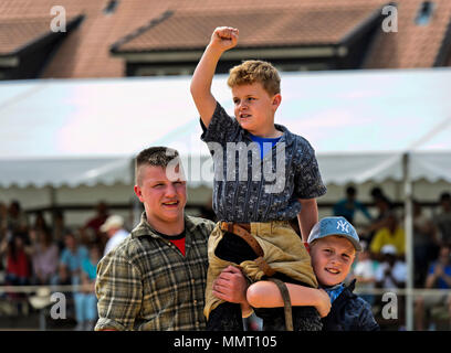 Anières, Geneva, Switzerland. 12 May 2015. The winner in a children's category on the shoulders of his friends, 19th Swiss wrestling festival of the Canton of Geneva, Anières, Geneva, Switzerland. Credit: GFC Collection/Alamy Live News Stock Photo