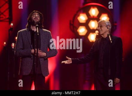 12 May 2018, Portugal, Lisbon: Last year's winner Salvador Sobral (l) and Brazilian singer Caetano Veloso perform at the finals of the 63rd Eurovision Song Contest. Photo: Jörg Carstensen/dpa Stock Photo