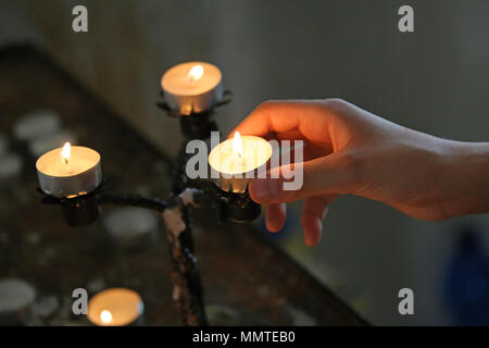 Little Girl Puts A Candle In Church. Orthodoxy And Children Stock Photo 