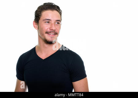 Close up of young happy man smiling and thinking isolated agains Stock Photo
