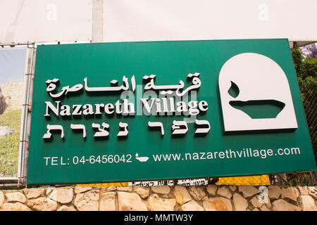 A sign advertising the Nazareth Village experience for tourists at the excavated site of the ancient village of Nazareth in Israel Stock Photo