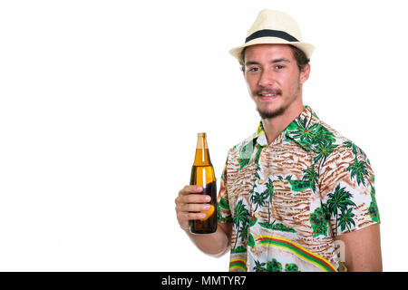 Studio shot of young happy tourist man smiling while holding bot Stock Photo