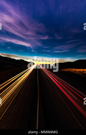 MARCH 12, 2017, LAS VEGAS, NV - streaked lights at sunset over Interstate 15, south of Las Vegas, Nevada at sunset Stock Photo